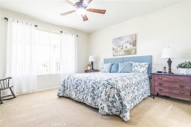 bedroom with light carpet and ceiling fan