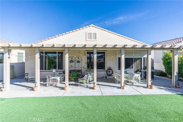 rear view of property featuring a patio area