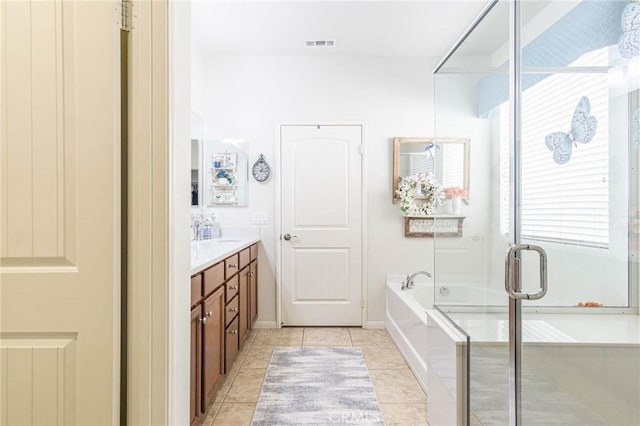 bathroom featuring vanity, separate shower and tub, and tile patterned floors