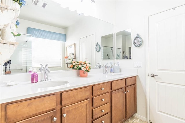 bathroom with a shower with door and vanity