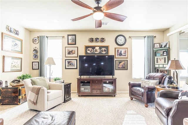 carpeted living room with ceiling fan