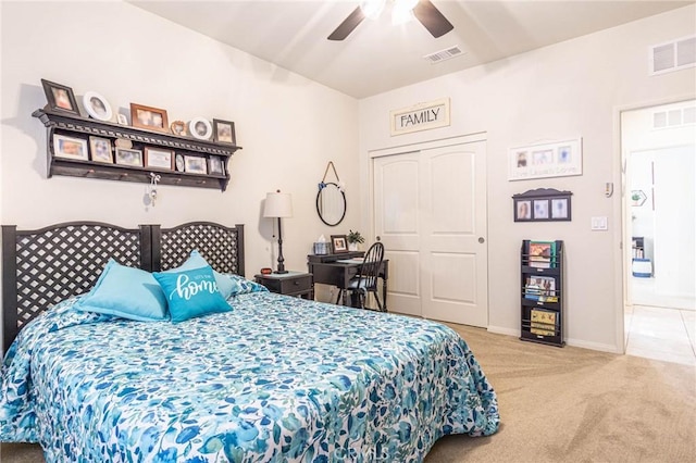 carpeted bedroom with ceiling fan and a closet