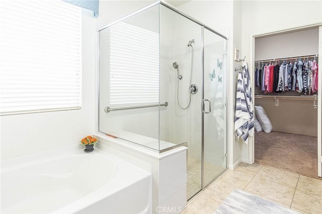 bathroom featuring tile patterned flooring and independent shower and bath