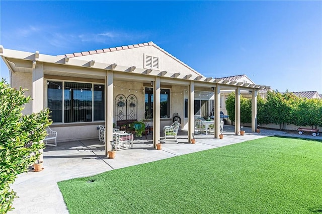 back of house featuring a lawn and a patio area