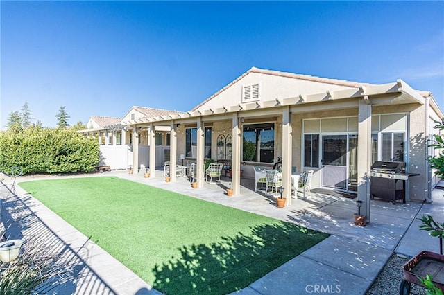 back of house featuring a yard and a patio area