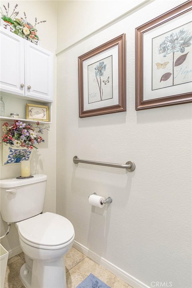 bathroom with toilet and tile patterned floors