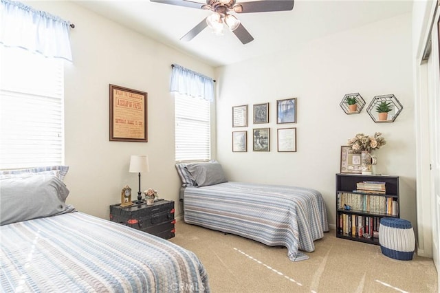 bedroom featuring light colored carpet and ceiling fan