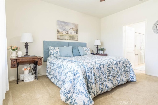 bedroom with ceiling fan, carpet floors, and ensuite bath