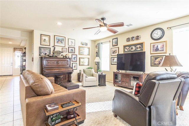 tiled living room featuring ceiling fan and a healthy amount of sunlight