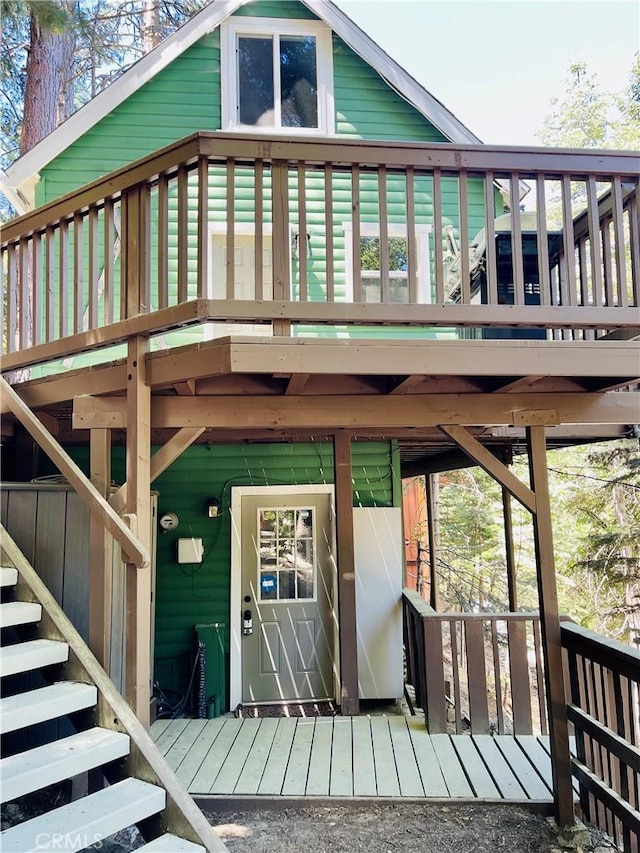 rear view of property featuring stairway