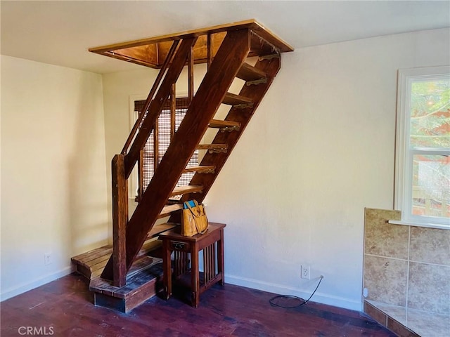 stairs featuring baseboards and wood finished floors