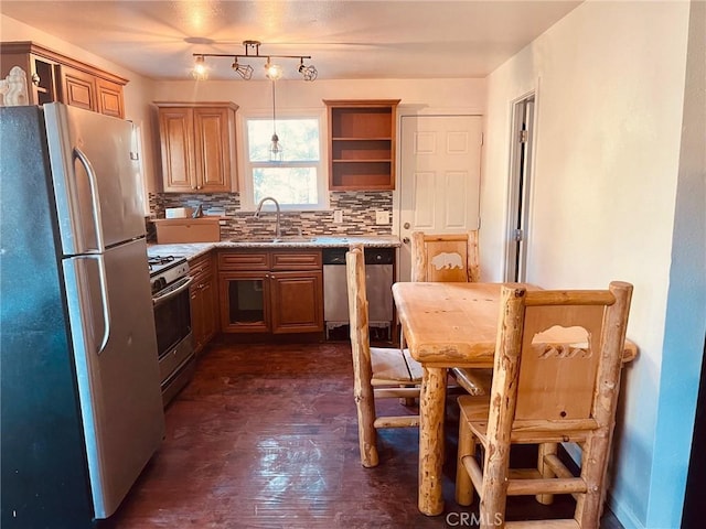 kitchen with light stone counters, stainless steel appliances, a sink, decorative backsplash, and open shelves