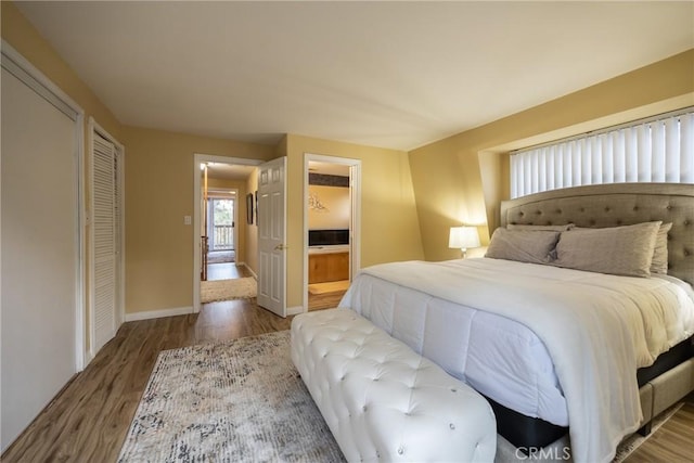 bedroom with a closet and hardwood / wood-style floors