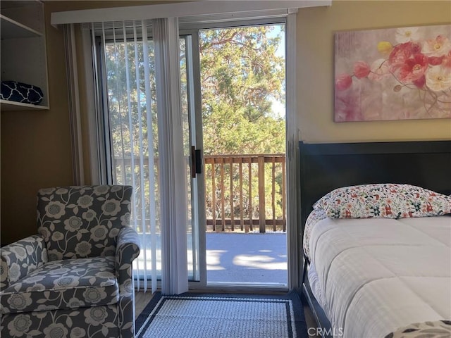 bedroom with access to outside and carpet floors