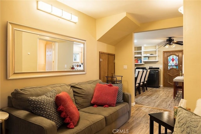 living room featuring ceiling fan and light wood-type flooring