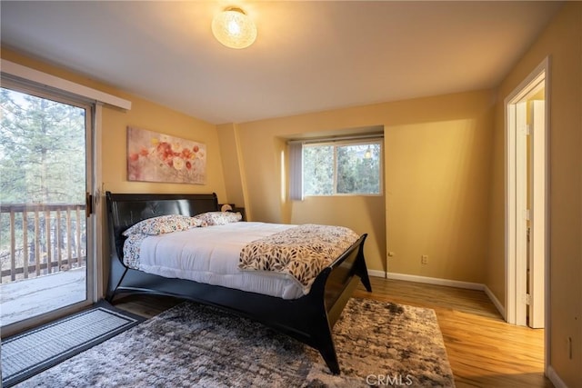 bedroom featuring access to outside and light hardwood / wood-style floors