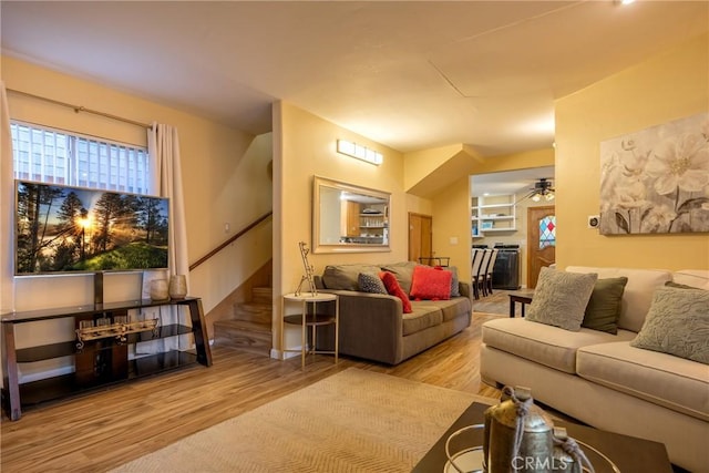 living room featuring ceiling fan and light hardwood / wood-style floors