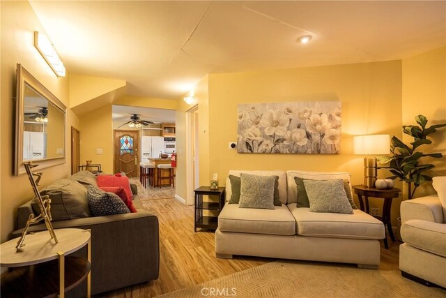 living room featuring ceiling fan and light wood-type flooring