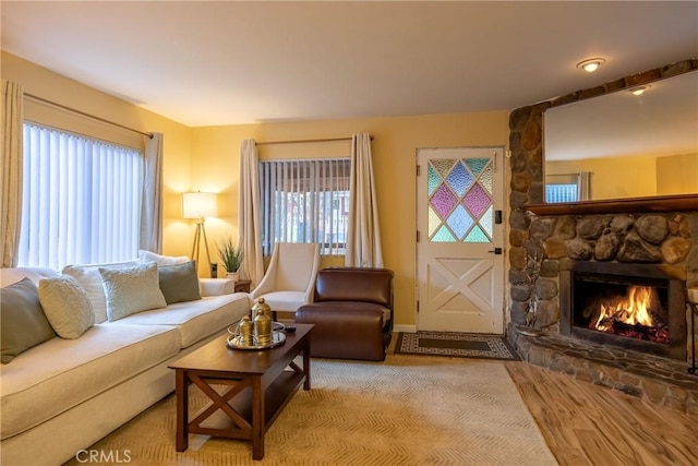 living room featuring a stone fireplace