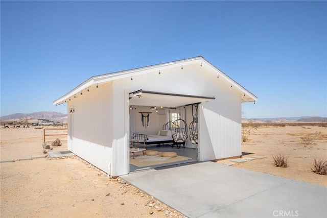 exterior space with a mountain view and an outdoor structure