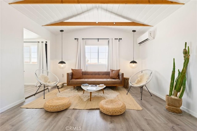 living area with a wall mounted air conditioner, vaulted ceiling with beams, and plenty of natural light