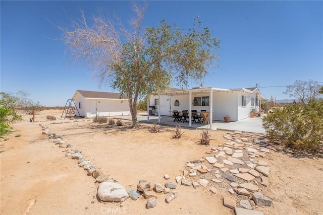 back of property with a patio area