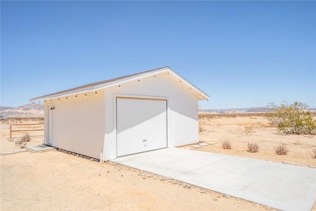 view of outdoor structure with a mountain view and a garage