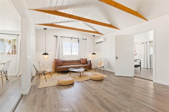 living area featuring vaulted ceiling with beams, a wealth of natural light, wood-type flooring, and a wall mounted air conditioner