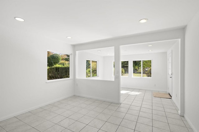 unfurnished room featuring light tile patterned floors and a healthy amount of sunlight