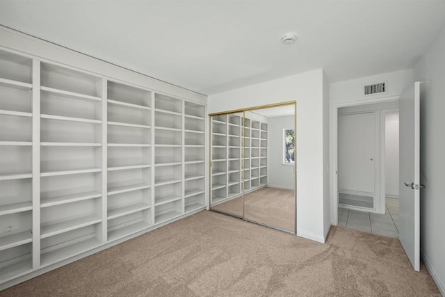 unfurnished bedroom featuring carpet floors and a closet