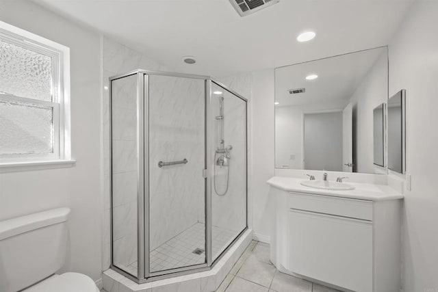 bathroom with vanity, toilet, and an enclosed shower