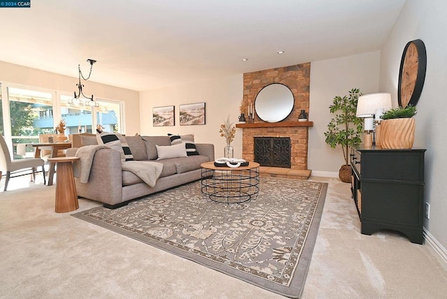 living room featuring a fireplace, light carpet, and a chandelier