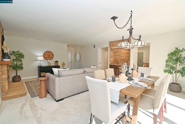 carpeted dining space featuring a notable chandelier