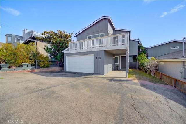 view of front property with a balcony and a garage