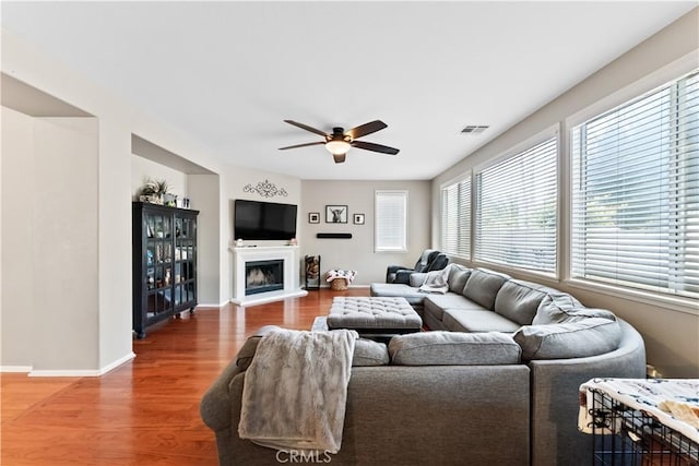 living room with wood-type flooring and ceiling fan