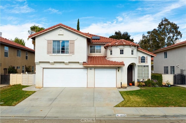 mediterranean / spanish house featuring a front yard, solar panels, and a garage