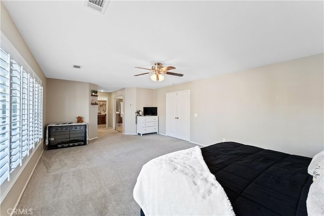 carpeted bedroom with ceiling fan and multiple windows