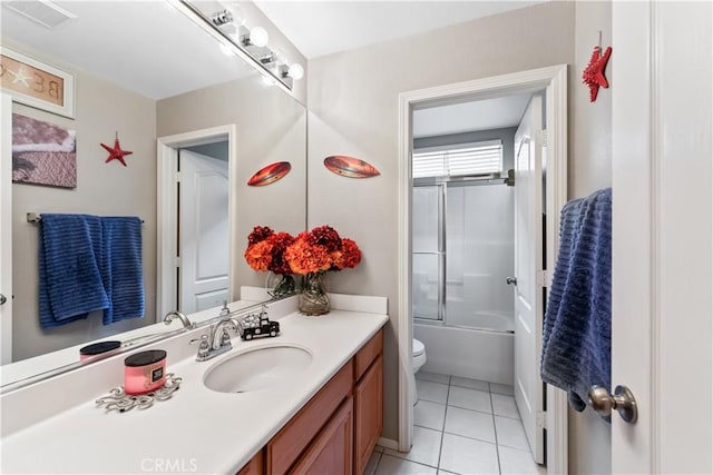 full bathroom with tile patterned flooring, vanity, toilet, and enclosed tub / shower combo