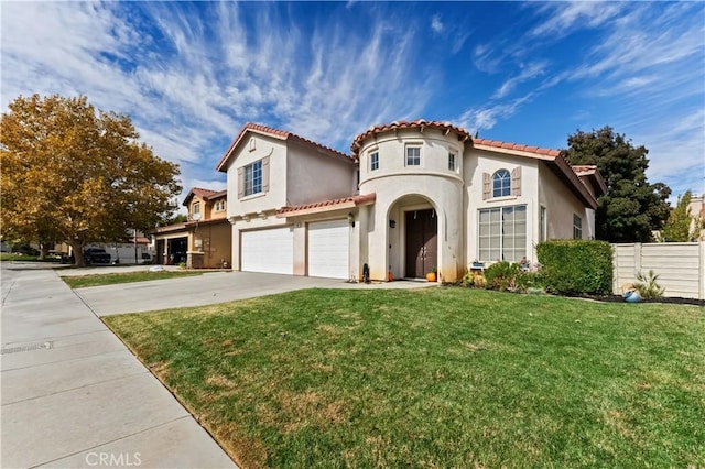 mediterranean / spanish home with a garage and a front lawn