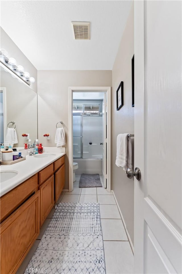 full bathroom with tile patterned flooring, vanity, shower / bath combination, and toilet