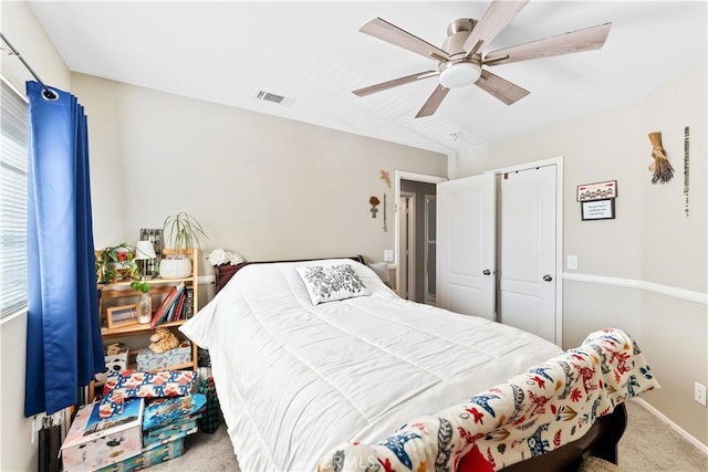 carpeted bedroom with ceiling fan and a closet