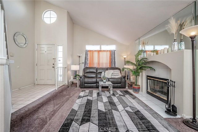 living room with a tile fireplace, high vaulted ceiling, and light tile patterned floors