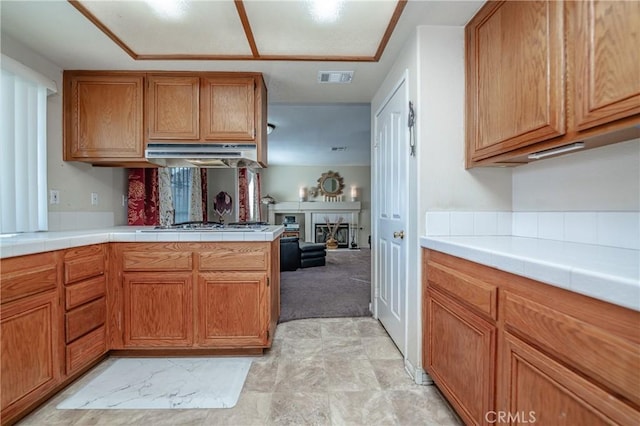 kitchen featuring tile counters and kitchen peninsula