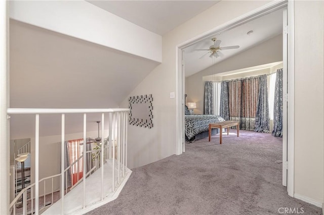 hallway featuring carpet flooring and lofted ceiling