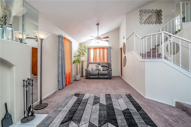 entrance foyer with carpet flooring, ceiling fan, and high vaulted ceiling