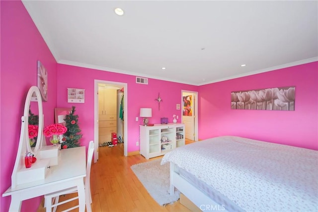 bedroom with crown molding and hardwood / wood-style flooring