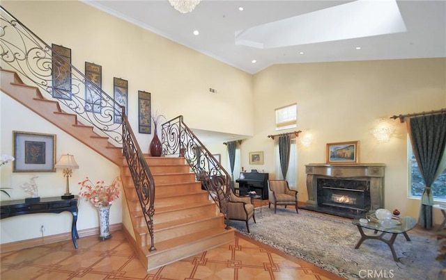 stairs with a fireplace and a high ceiling