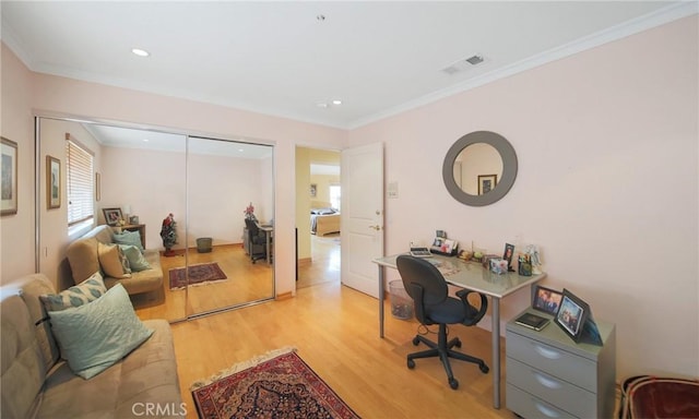 office space featuring light hardwood / wood-style flooring and crown molding