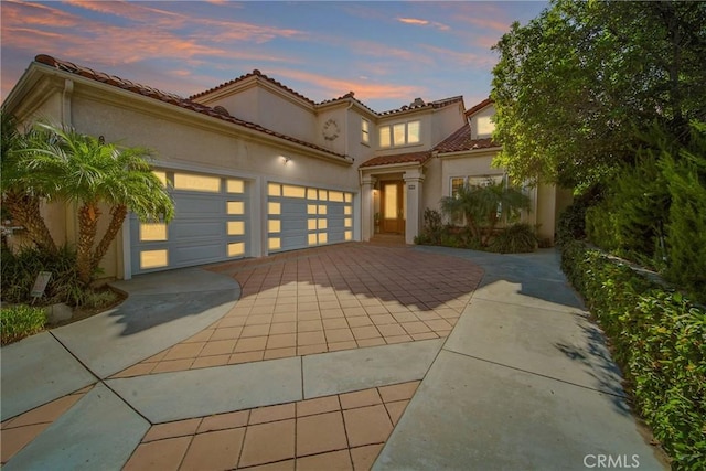 mediterranean / spanish-style house featuring a garage