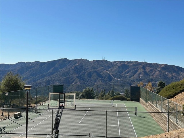 view of tennis court with a mountain view